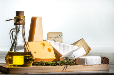 Different sorts of cheese. Cheese platter with different cheese and spices on white background
