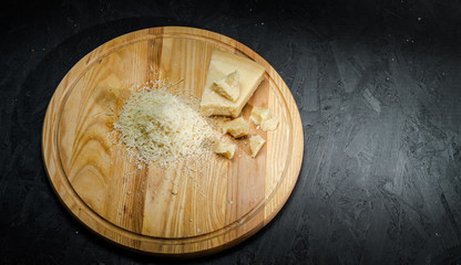 Delicious dutch cheese on dark background. Copy space