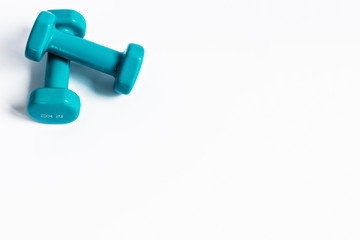 Blue dumbbells for fitness on a white background. Healthy lifestyle.