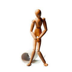 Wooden man stands next to a roll of toilet paper. Concept of the problem with digestion.