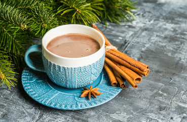 Cup of hot chocolate in winter decorations on the rustic background. Selective focus. Shallow depth of field.