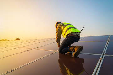Portrait of engineer man or worker, people, with solar panels or solar cells on the roof in farm....