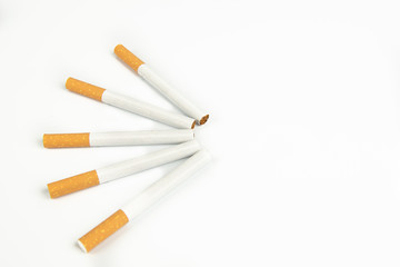 Close up of group of unlit cigarettes isolated on a white background
