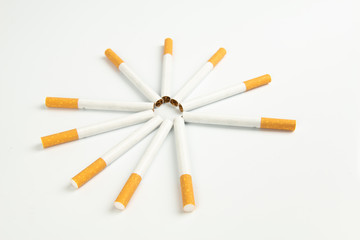 Close up of group of unlit cigarettes isolated on a white background