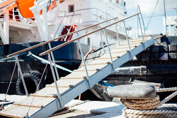 the ship is moored to a dock ladder rope chain