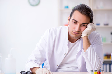 Young male chemist working in the lab