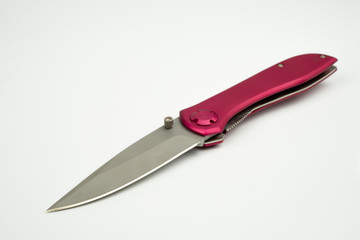 Close up of pink colour knife, isolated on white background