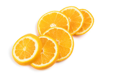 The juicy orange is cut across into round segments. The slices are folded in view of the timber on each other. White background