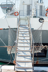 the ladder of the ship anchored to the berth of the port