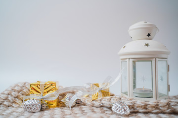 Christmas festive composition. New Year's gifts in yellow shiny paper with silver bows lie on a knitted blanket. Christmas concept