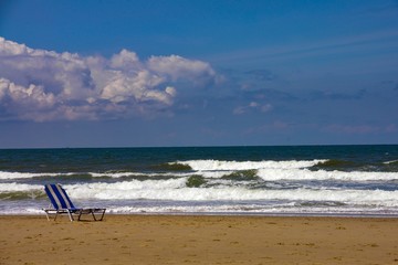 Fototapeta na wymiar Sun chair on sand beach
