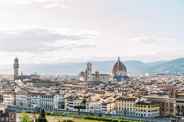 Fototapeta na wymiar A large panorama of the Italian city. Many beautiful historic houses and showplaces in Florence. Travelling Europe