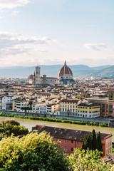 Fototapeta na wymiar Dome of the Catholic temple. Charming city with beautiful architecture on the banks of the river. The river in Florence. Travelling Italy