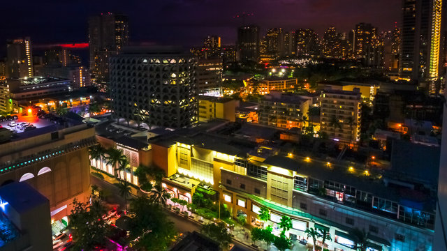 Colorful night life lights of Waikiki city from top overlook. Oahu island Hawaii, United States. City night lights and nightlife concept.