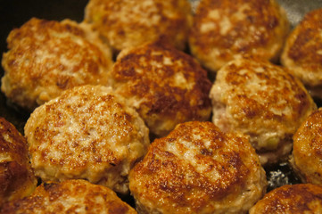 Fried meat cutlets rissole meatballs of minced pork in a pan.