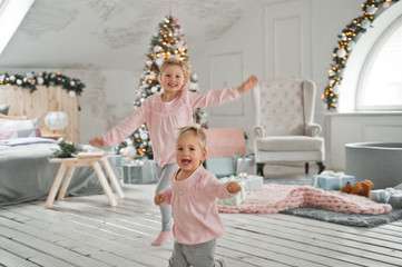 Little girls run around the Christmas decorated house 2064.