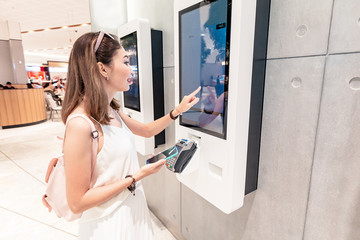 The girl makes an order in a fast food restaurant at the self-service terminal in the Mall. Modern technologies and displacement of manual labor