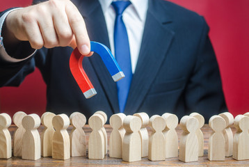 Businessman looking for new employees with a magnet. Search for professionals specialists for open...