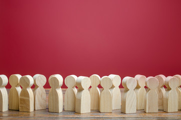 A crowd of wooden figures of people. Society, demography. Customers and buyers, statistics, preferences of Population. group of citizens, rally, political movement or electorate. Employees. Copy space