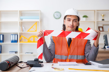 Young male architect working in the office