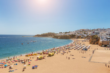 Famous tourist beach with fishermen in Albufeira, Portugal.