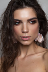 Obraz premium Portrait of a beautiful brunette girl with hazel eyes and square jaw and chin. Perfect skin, light professional make up.