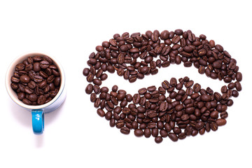 Coffee bean shape created with coffee beans and a mug