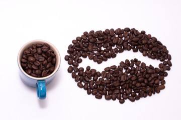 Coffee bean shape created with coffee beans and a mug