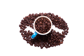 Coffee bean shape created with coffee beans and a mug