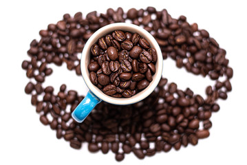 Coffee bean shape created with coffee beans and a mug