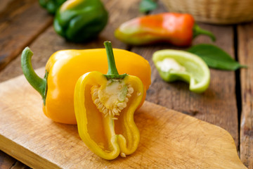 sliced bell peppers on wooden background