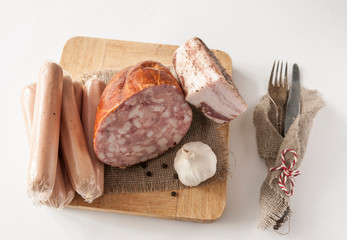 Meat cutting on a board, lard on white background. Top view