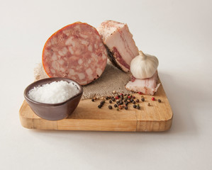 Meat cutting on a board, lard on white background. Top view