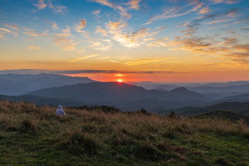 Silhouette of people watching  the sunset from Max Patch bald over the Great Smoky Mountains