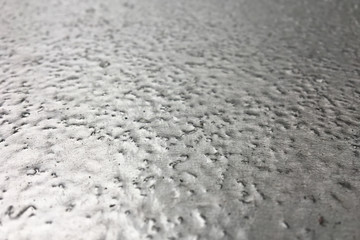 stainless steel surface covered with ice crust.