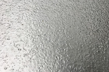 stainless steel surface covered with ice crust.