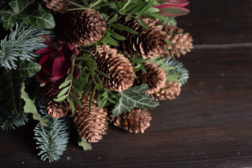 Winter bouquet of Nobil fir twigs, cones, pistachio, leucodendron and ivy, winter gift concept