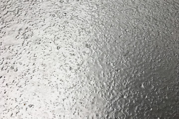 stainless steel surface covered with ice crust.
