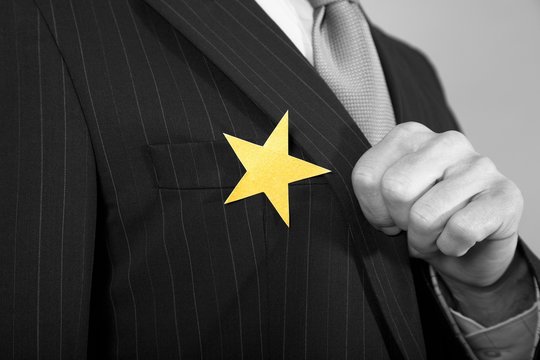Businessman With Gold Star On Suit