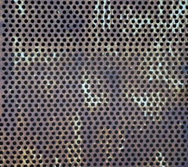 Texture of an old rusty round hole perforated metal