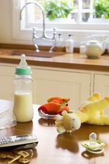Baby Items With Cellphone And Keys On Kitchen Counter