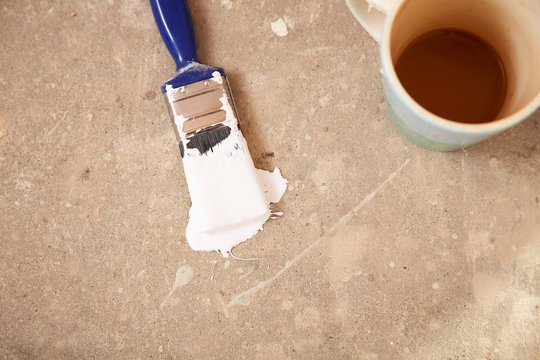 Coffee Mug And Paintbrush On Floor