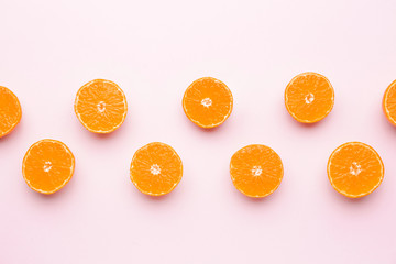Pieces of sweet tangerines on color background