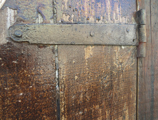 Old wooden background with rusty hinge. Tropical construction. Martinique. French West Indies