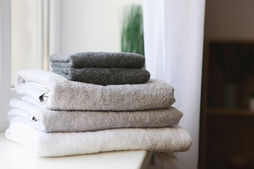 a stack of fresh towels on the table.