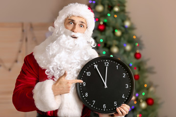 Santa Claus with clock in room. Christmas countdown concept