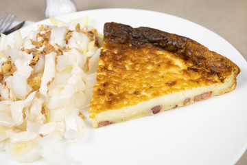 slice of quiche and endive salad