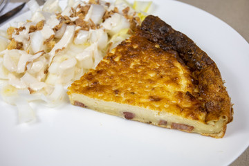 slice of quiche and endive salad