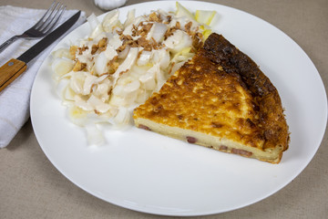 slice of quiche and endive salad