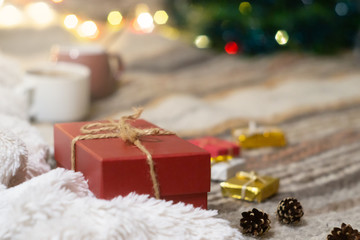 Gift box on the background of a Christmas tree with lights